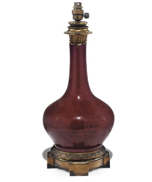 A CHINESE SANG-DE-BOUEF PORCELAIN AND GILT-BRONZE MOUNTED LAMP