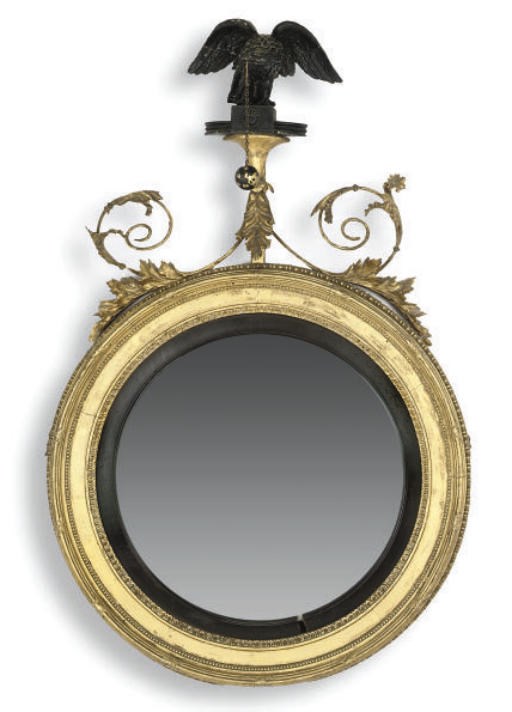 A REGENCY GILTWOOD COMPOSITION AND EBONISED CONVEX MIRROR