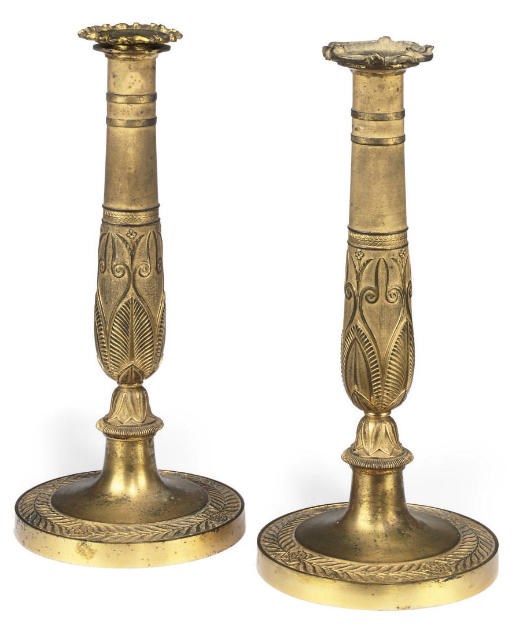 A PAIR OF FRENCH EMPIRE ORMOLU CANDLESTICKS