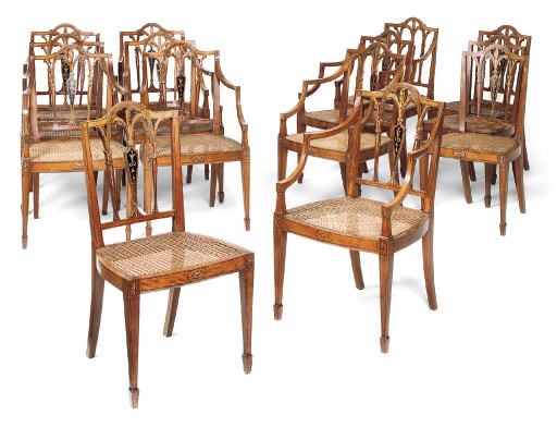A SET OF FOURTEEN LATE VICTORIAN SATINWOOD AND POLYCHROME DECORATED CHAIRS