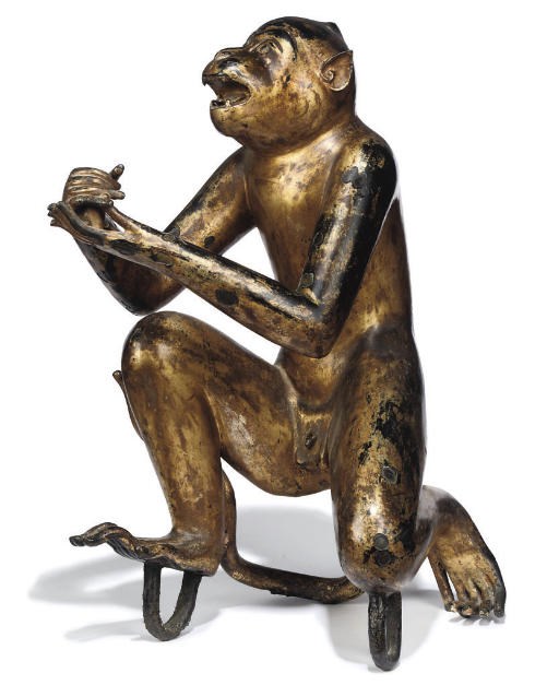 A SOUTH EAST ASIAN LACQUERED AND GILT-METAL MODEL OF A MONKEY