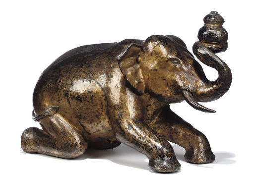 A SOUTHEAST ASIAN LACQUERED AND GILT-METAL MODEL OF AN ELEPHANT