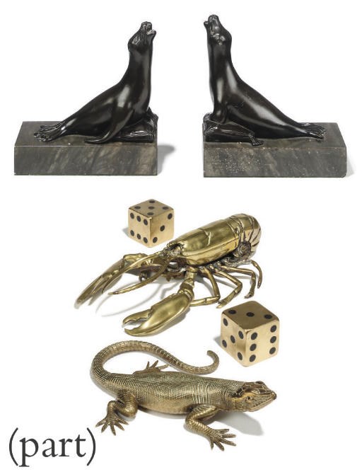 A PAIR OF BRONZE BOOKENDS, MODELLED AS SEALS ON MARBLE PLINTHS