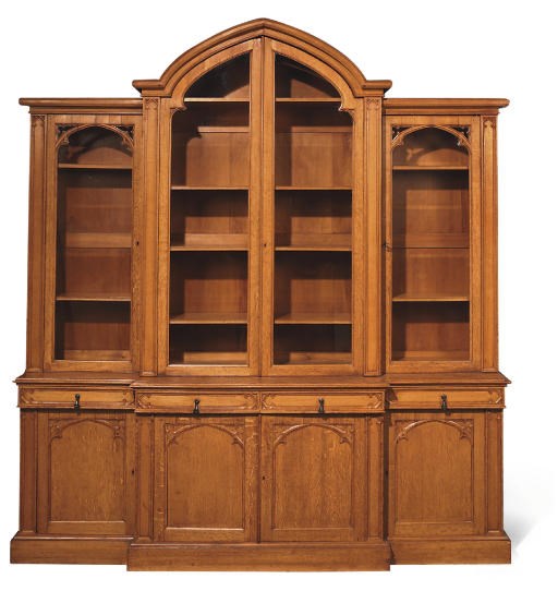 AN EARLY VICTORIAN GOTHIC OAK BREAKFRONT BOOKCASE