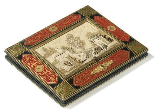 AN ITALIAN GILTMETAL MOUNTED GILT EMBOSSED AND EMBROIDERED CONCERTINA LETTER FOLDER