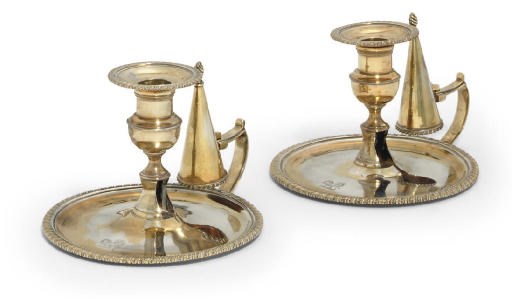 A PAIR OF GEORGE III SILVER-GILT CHAMBER-CANDLESTICKS