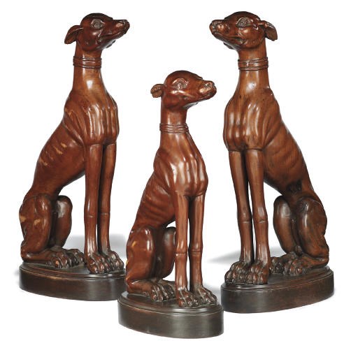 A SET OF THREE ITALIAN WALNUT MODELS OF SEATED WHIPPETS
