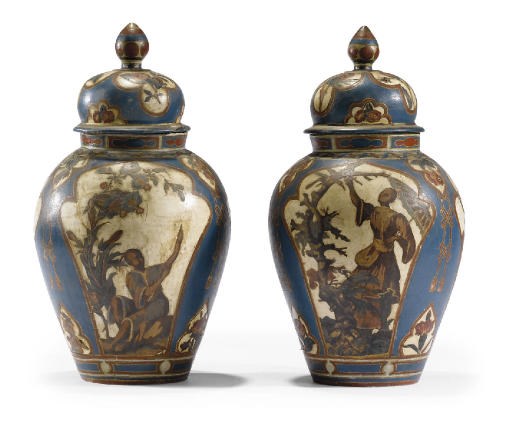 A PAIR OF PIEDMONTESE BLUE AND POLYCHROME-DECORATED TERRACOTTA LIDDED BALUSTER SHAPED VASES