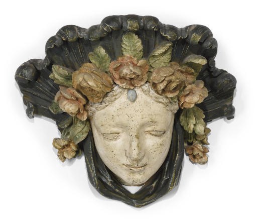 A NORTH ITALIAN CARVED AND POLYCHROME-DECORATED WALL-BRACKET IN THE FORM OF THE HEAD OF A GIRL
