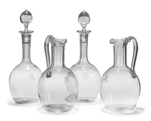 A PAIR OF MONOGRAMMED DECANTERS AND STOPPERS AND TWO MATCHING EWERS