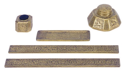 AN AMERICAN GILT-BRONZE 'ZODIAC' PATTERN PART DESK SET,