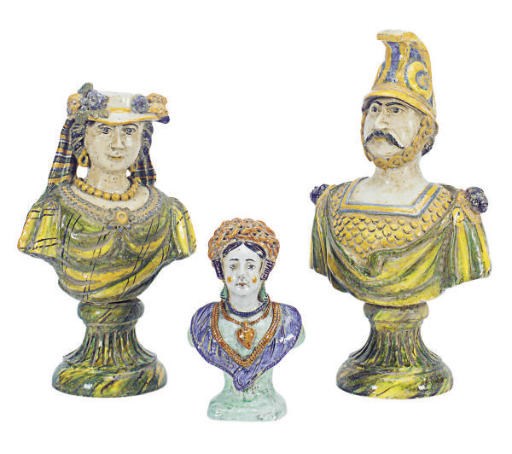 A PAIR OF TIN-GLAZED EARTHENWARE BUSTS OF A NEOPOLITAN SOLDIER AND COMPANION,