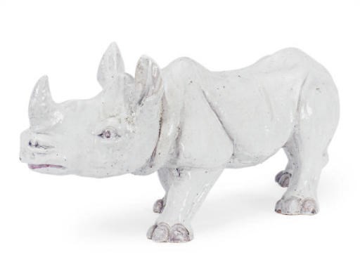 A WHITE-GLAZED CERAMIC RHINOCEROUS MODEL,