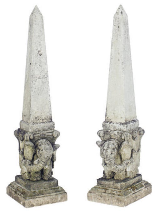 A PAIR OF STONE OBELISKS ON ELEPHANT FORM PEDESTAL BASES,
