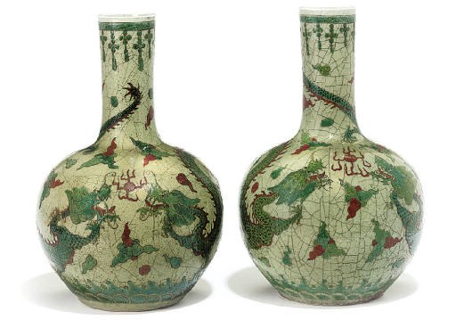 A pair of Chinese celadon glazed 'dragon' bottle vases