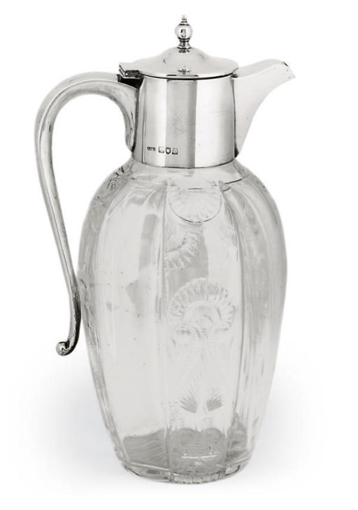 AN EDWARDIAN SILVER-MOUNTED CLARET JUG,