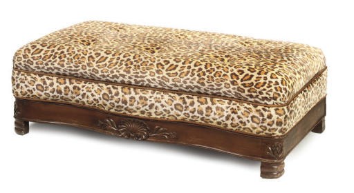 A LEOPARD PRINT UPHOLSTERED OTTOMAN