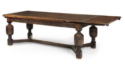 AN OAK DRAWER LEAF DINING TABLE