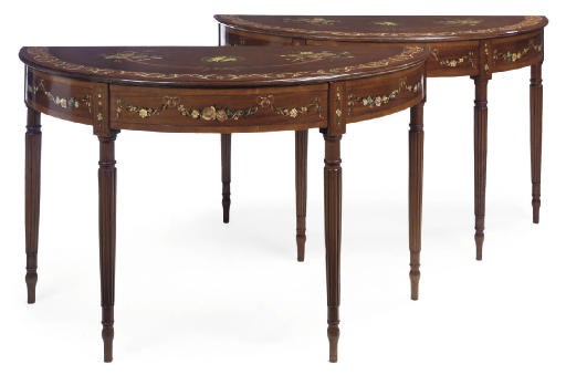 A PAIR OF MAHOGANY CROSSBANDED AND POLYCHROME DECORATED DEMI LUNE CONSOLE TABLES