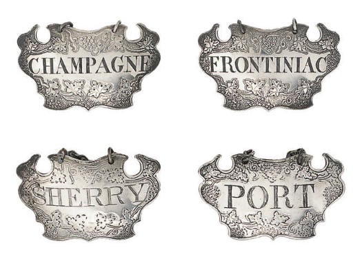 A SET OF THREE GEORGE II SILVER ESCUTCHEON WINE LABELS,