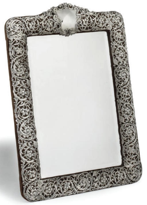 AN EDWARDIAN SILVER DRESSING TABLE MIRROR WITH EASEL BACK,