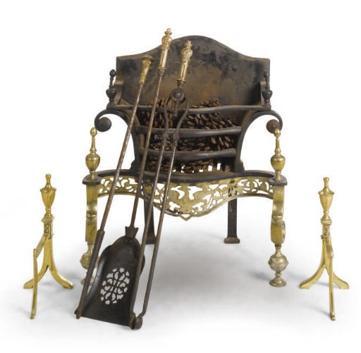 A BRASS MOUNTED CAST IRON FIRE-GRATE
