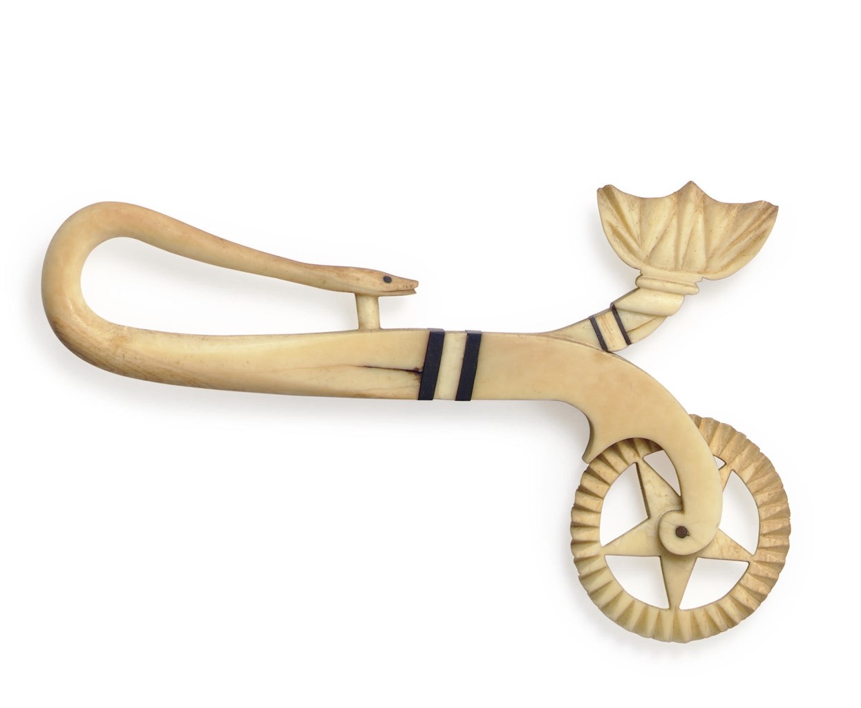 AN IVORY, BALEEN, AND EBONY 'GARDEN OF EDEN' JAGGING WHEEL