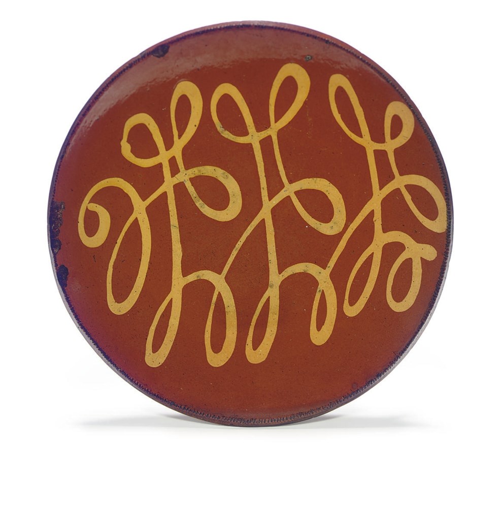 A SLIP-DECORATED REDWARE CHARGER