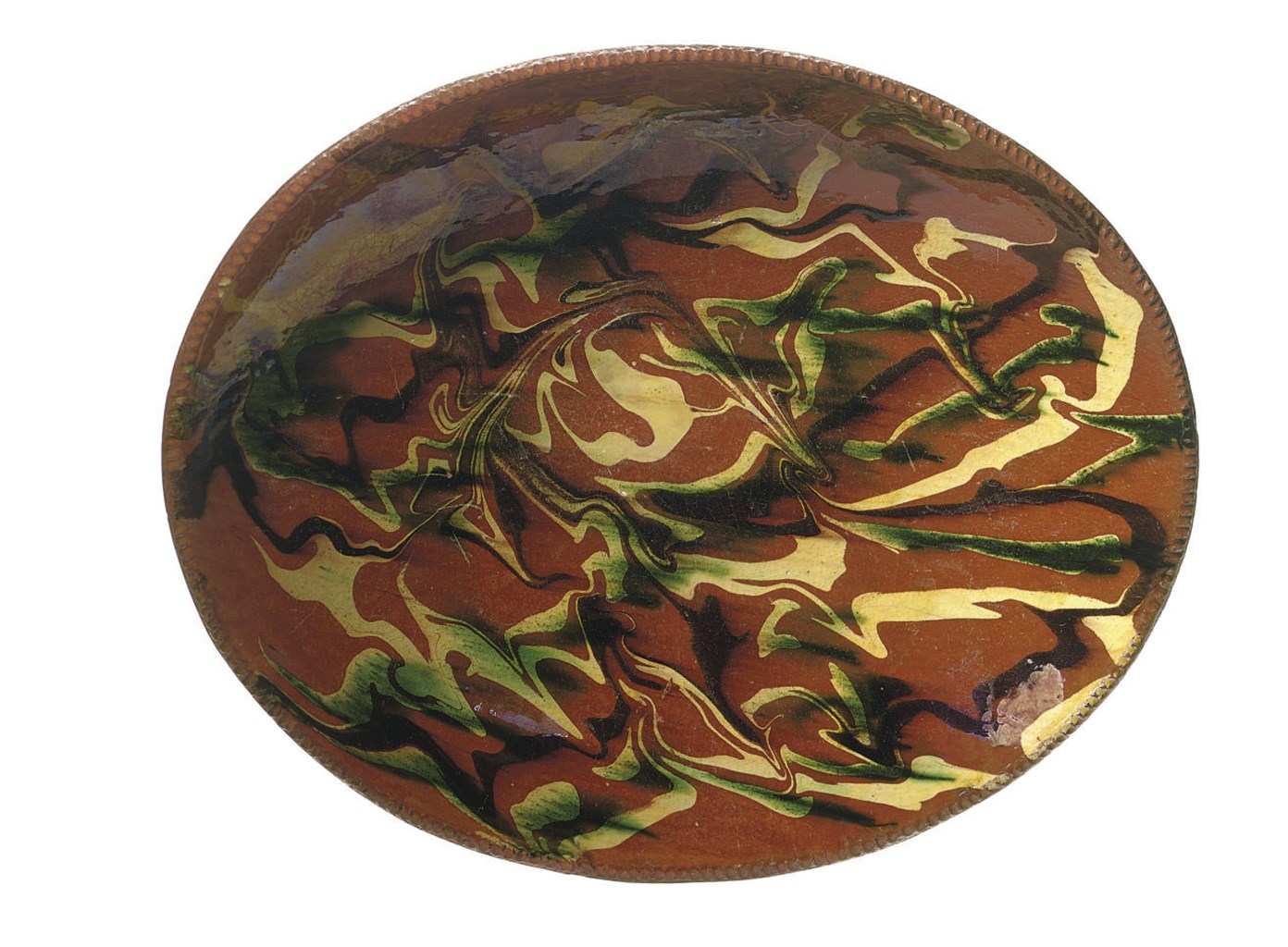 AN OVAL SLIP-DECORATED REDWARE DISH
