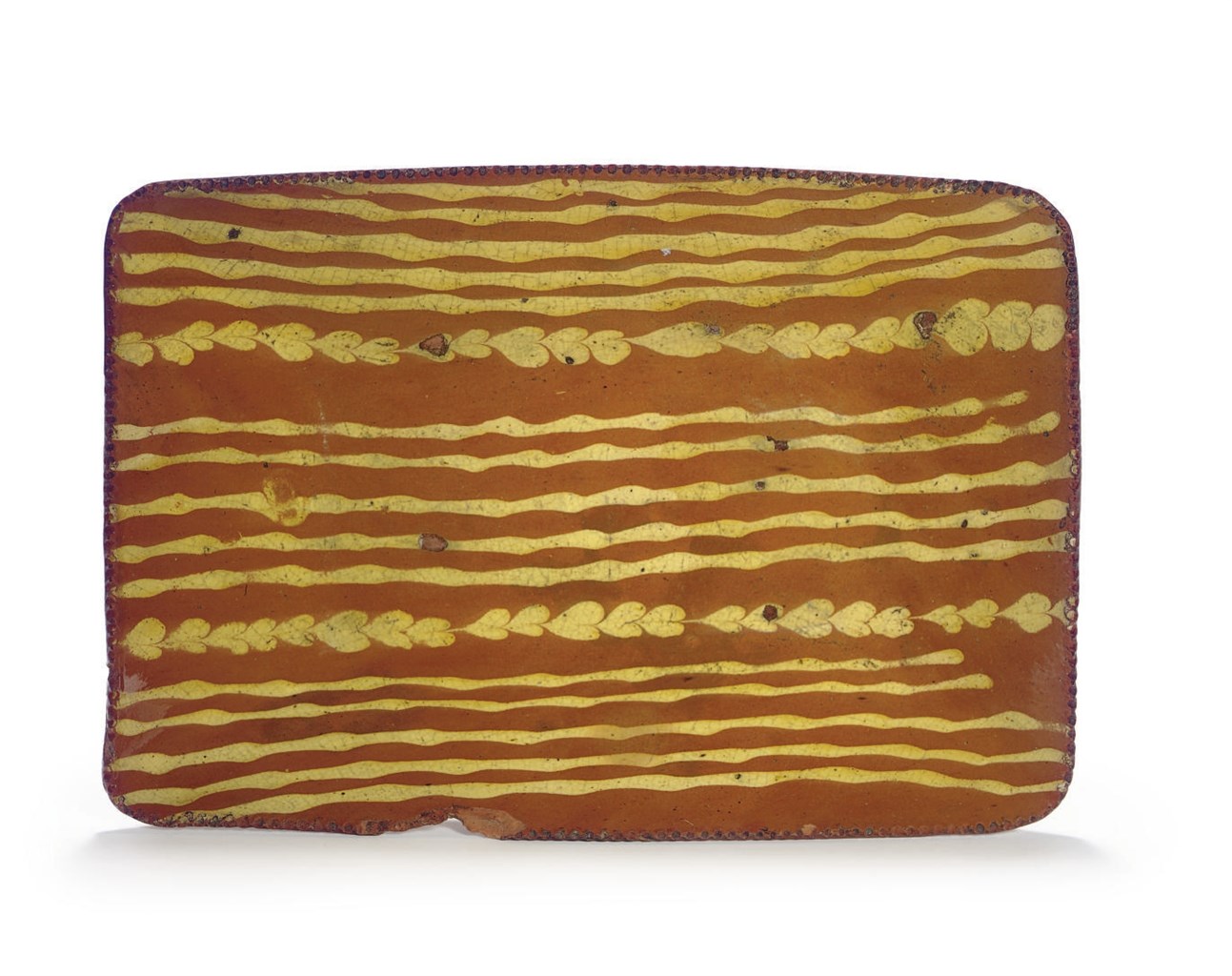 A SLIP-DECORATED REDWARE DISH