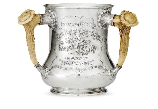 A SILVER THREE-HANDLED TROPHY CUP