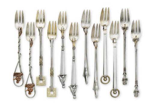 A SET OF TWELVE PARCEL-GILT SILVER AND MIXED-METAL SEAFOOD FORKS