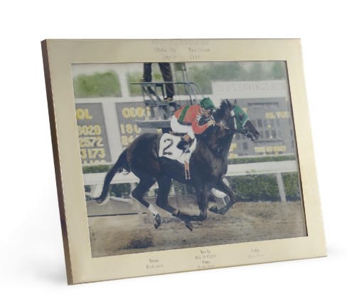 A GOLD TROPHY PICTURE FRAME: WON BY HAIL TO REASON