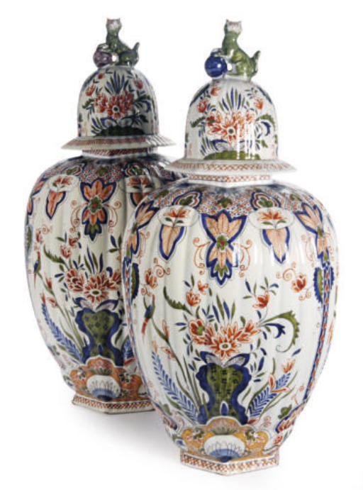 A PAIR OF DUTCH DELFT POLYCHROME TIN-GLAZED EARTHENWARE RIBBED VASES AND COVERS,