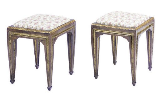 A PAIR OF CONTINENTAL FRUITWOOD AND PARCEL-GILT STOOLS,