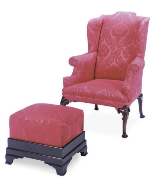 A MAHOGANY AND DAMASK UPHOLSTERED WINGBACK ARMCHAIR AND FOOTSTOOL,