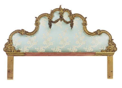 A GILTWOOD UPHOLSTERED HEADBOARD,