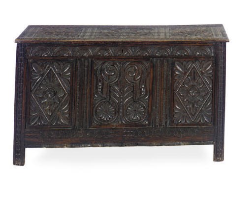 AN ENGLISH CARVED OAK COFFER,