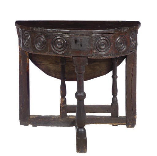 AN ITALIAN WALNUT CIRCULAR STORAGE TABLE,