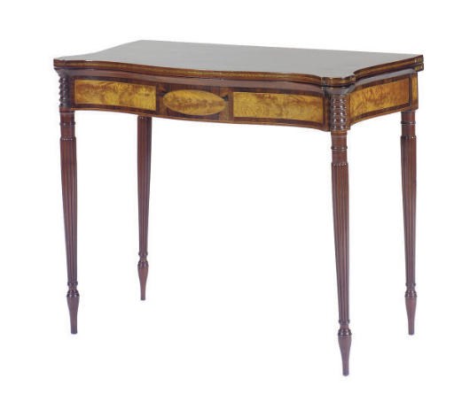 A MAHOGANY AND FLAME BIRCH SERPENTINE GAMES TABLE,