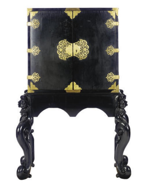A GILT-METAL MOUNTED CARVED EBONY CABINET ON STAND,