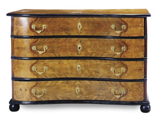 A GERMAN WALNUT AND PART-EBONIZED COMMODE,