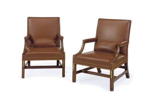 A PAIR OF GEORGE III MAHOGANY AND PARCEL-GILT LIBRARY OPEN ARMCHAIRS