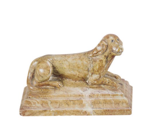 A MARBLE FIGURE OF A RECLINING DOG,