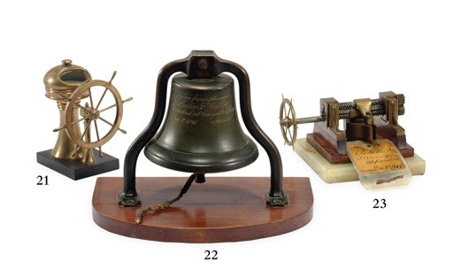 A miniature binnacle and ship's wheel