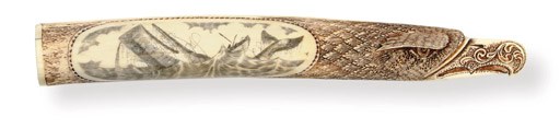 A 20th century scrimshaw and carved walrus' tusk in the form of an eagle**