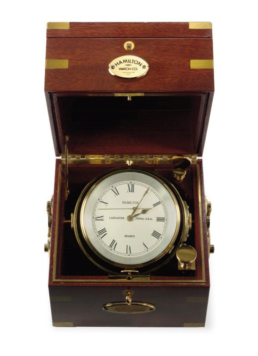 A modern marine chronometer in a three tiered mahogany box