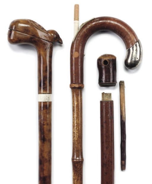 A GROUP OF FOUR MOUNTED GADGET WALKING CANES MAINLY RELATED TO SMOKING