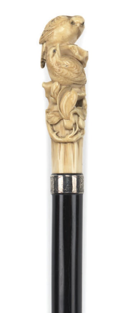 A JAPANESE CARVED IVORY AND EBONY MOUNTED WALKING STICK