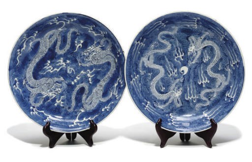 A matched pair of Chinese blue and white dragon dishes